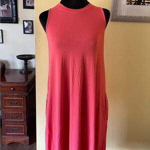 Cute dress knee length, color is orange. Sleeveless with pockets great condition